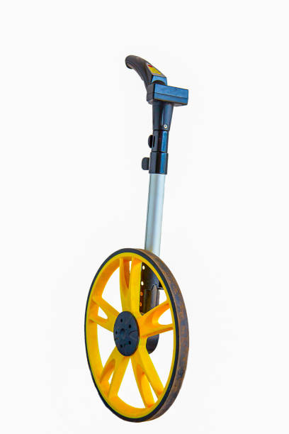 Surveyor's wheel or clickwheel used to measure distances on roads or pavements by road or utility maintenance workers stock photo
