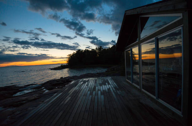 istock Sunset reflections on beach cottage after rain 804238260