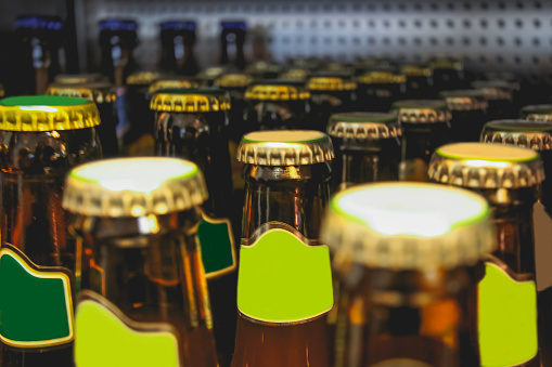 Collection of beer bottle placed in a row in liquor store
