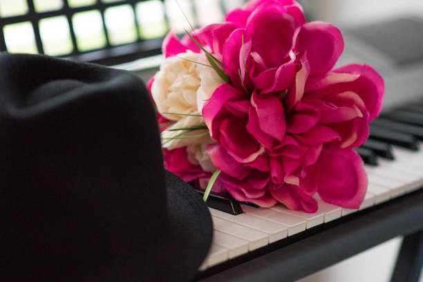 istock Flowers and a hat on the piano 804243854