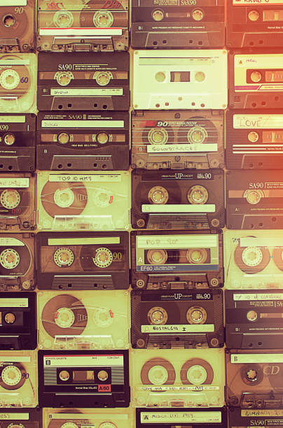 Retro audio cassettes background A background pattern made of vintage audio cassettes audio cassette photos stock pictures, royalty-free photos & images