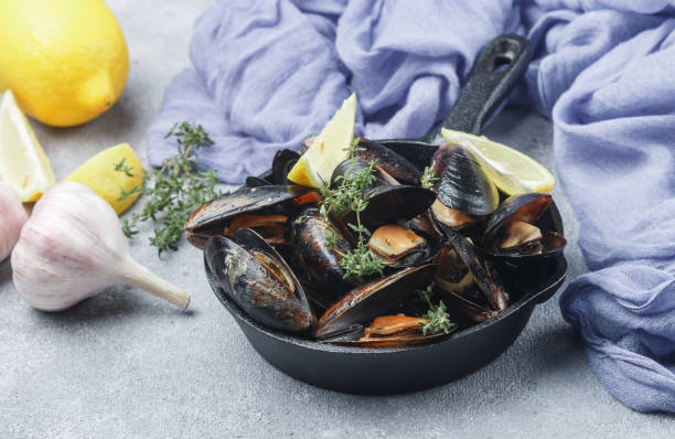istock Mussels in the shell with lemon, garlic and thyme. A delicious Mediterranean appetizer made of seafood. Selective focus 804256930
