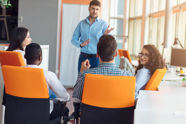 istock business, startup, presentation, strategy and people concept - man making presentation to creative team at office 804259542