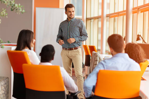 istock business, startup, presentation, strategy and people concept - man making presentation to creative team at office 804259716