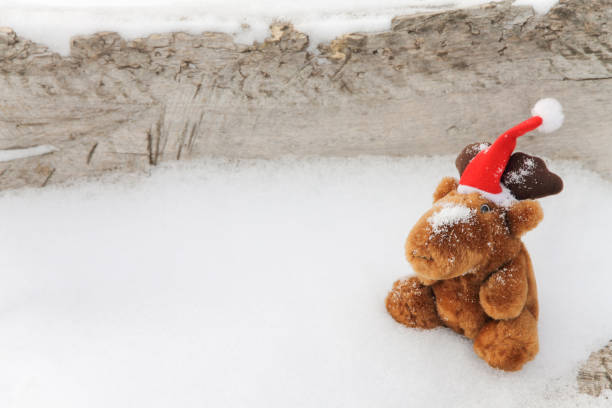 istock Toy deer on a snowy wooden background 804259888