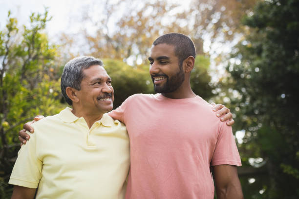 istock Smiling man looking at his father against trees 804260056