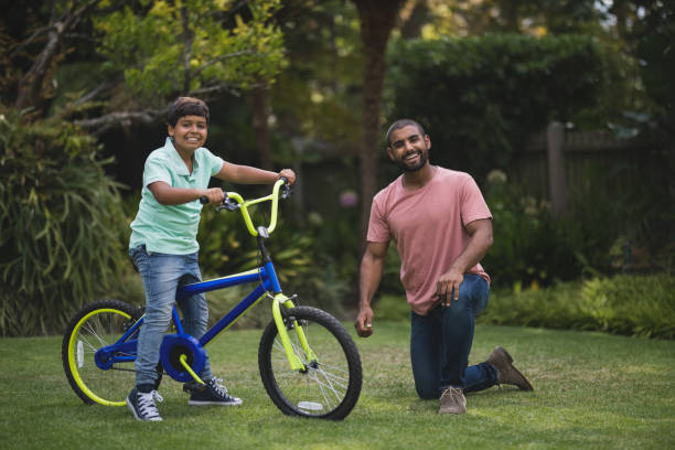 istock Portrait of father and son with bicycle 804266706