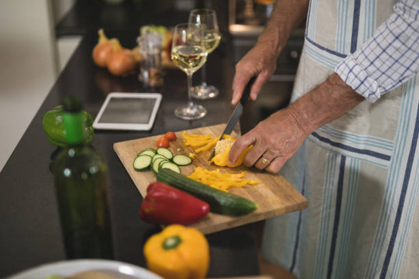 istock Mid section on man cutting bell pepper in kitchen 804269576