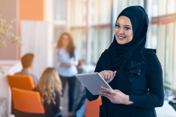 istock beautiful Arabian girl with tablet computer working at startup office 804269608
