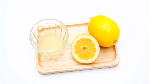 istock lemons on a wooden plate. 804279068