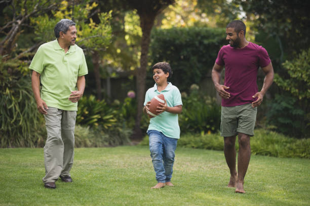 istock Boy with father and grandfather at park 804283196