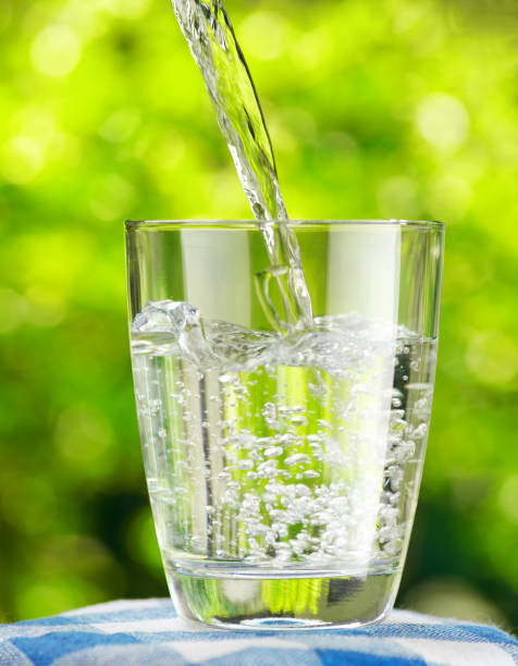 istock Glass of water on nature background 804287404