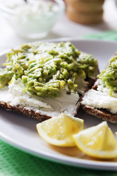 istock Avocado sandwich with cottage cheese and lemon close up 804291894