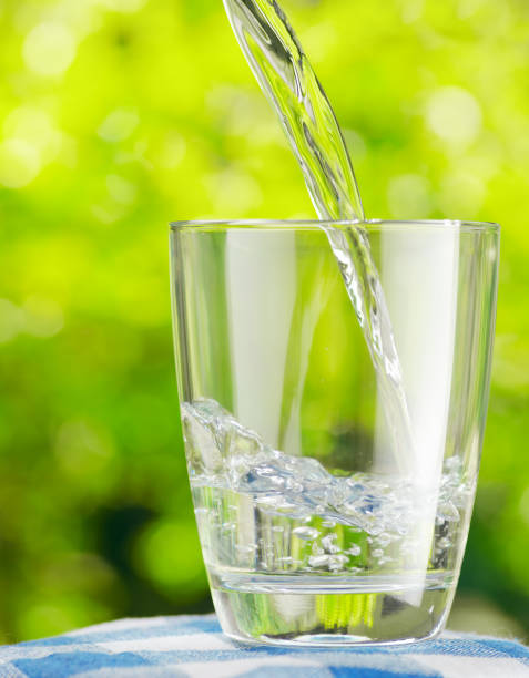 istock Glass of water on nature background 804292564