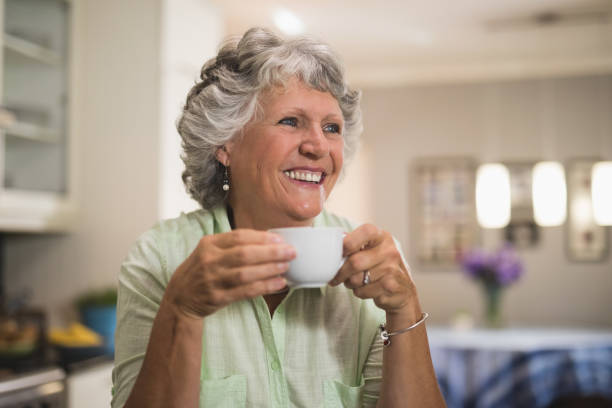 istock Happy senior woman holding cup at home 804295514