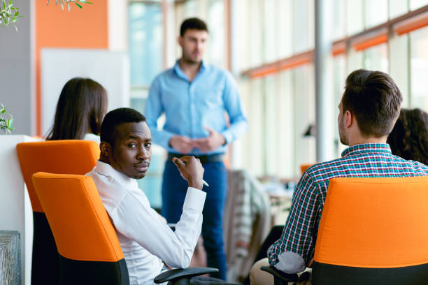 istock business, startup, presentation, strategy and people concept - man making presentation to creative team at office 804298904