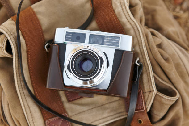 istock Vintage camera with backpack on the ground. Travel 804302176