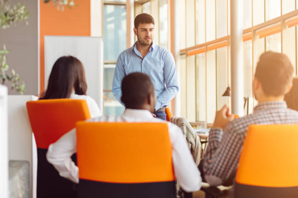 istock business, startup, presentation, strategy and people concept - man making presentation to creative team at office 804302308