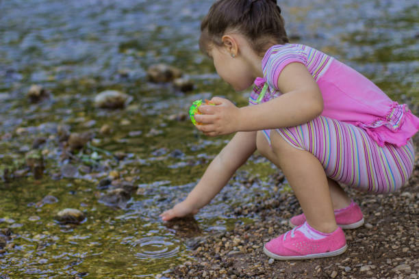 istock Young girl playing in the river 804312962
