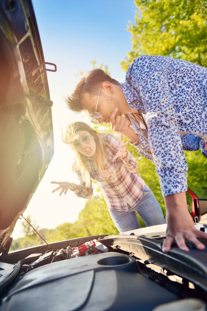 istock Young couple on the road has problems with their car 804313086