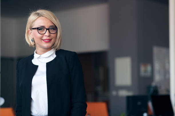 istock Happy young business woman with a folder at office building 804313768