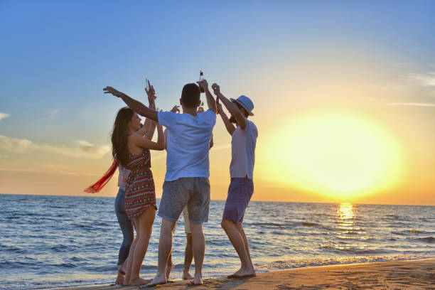 istock group of happy young people dancing at the beach on beautiful summer sunset 804317302