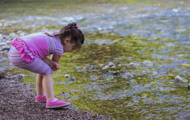 istock Young girl playing in the river 804330394