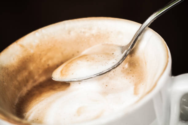 istock Cappuccino coffee. Milk foam in spoon 804336222