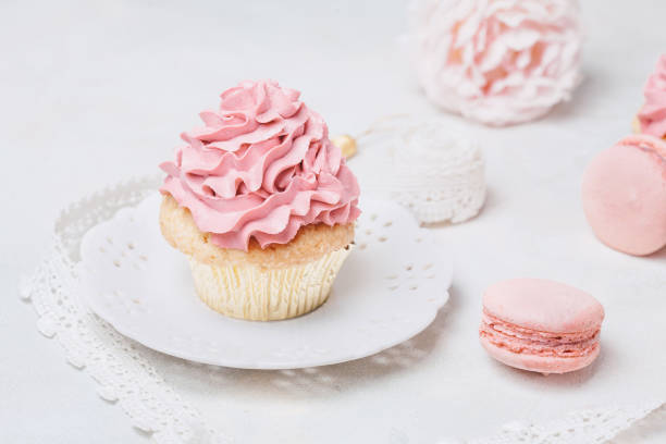 istock Pink cupcakes with roses and macaroons. Festive and bright. Wedding Celebration concept. 804342640