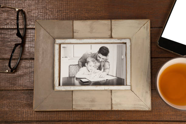 istock Photo frame, lemon tea and mobile phone on wooden plank 804342646