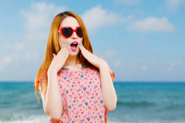 istock Girl with heart-shaped red sunglasses 804343706