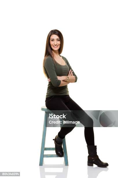 Happy Young Woman Stock Photo - Download Image Now - One Woman Only, Stool, Studio Shot