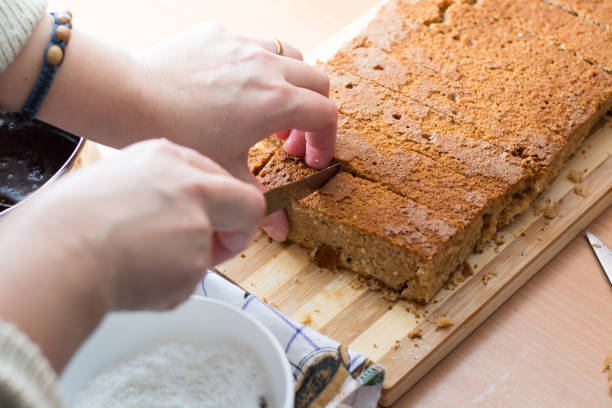 istock Female hands cutting and preparing cake crust 804350180