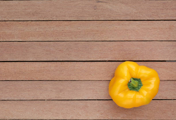 istock Yellow bell pepper on wood background. 804350470