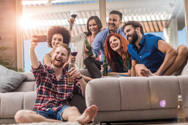 istock Happy friends having fun while taking a selfie on a home party. 804353404