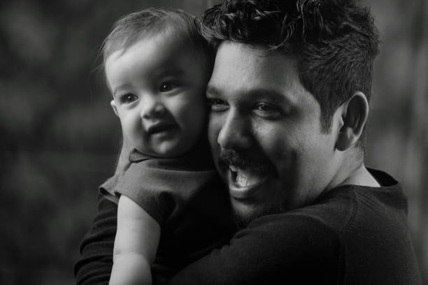 istock Happy man holding a baby 804353928