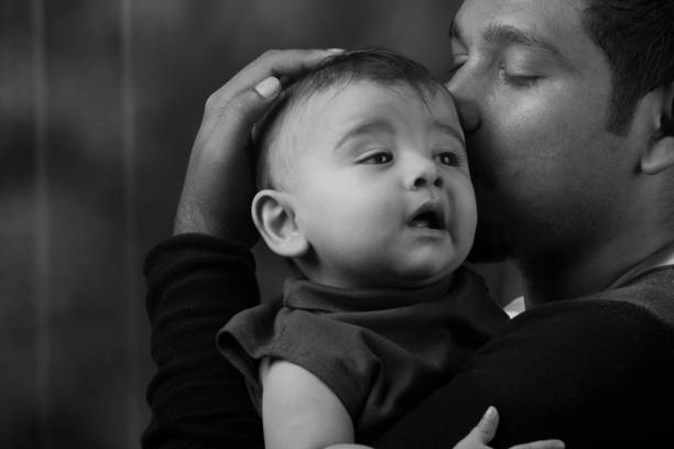 istock Happy man holding a baby 804354098