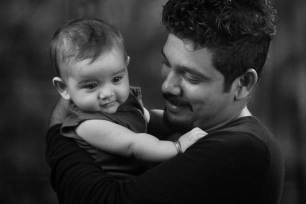Happy man holding a baby
