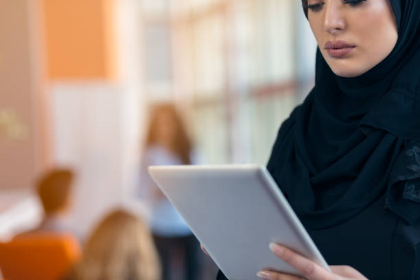istock beautiful Arabian girl with tablet computer working at startup office 804354688