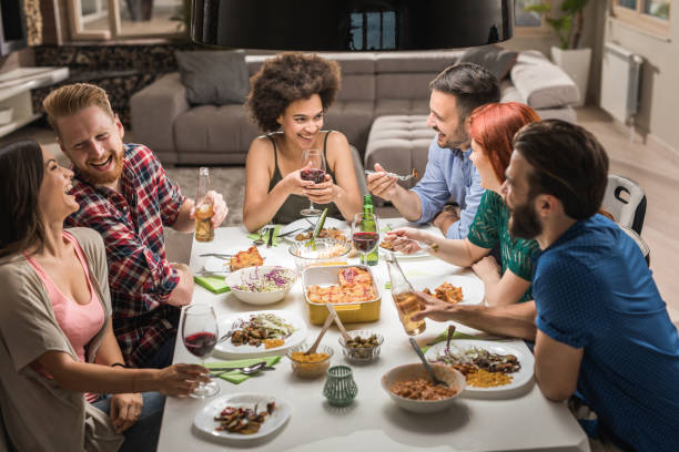 istock Large group of happy friends having fun while talking on a dinner party. 804357810