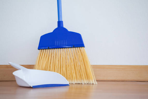 istock Dustpan and sweeping broom on wooden floor 804368170
