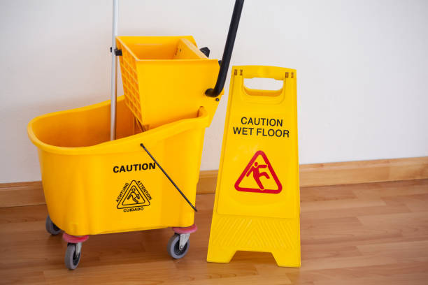 istock Yellow sign board with mop bucket on floor against wall 804368748