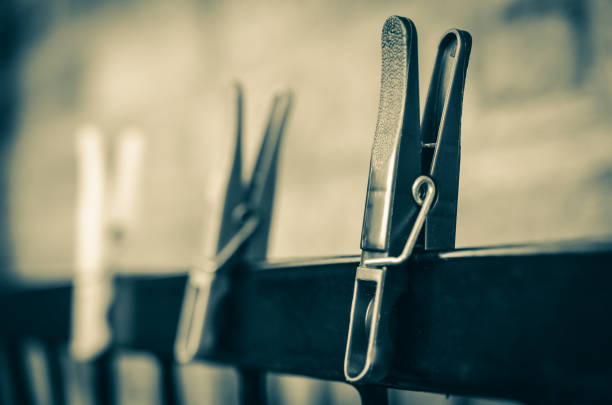 Sepia clothes pegs stock photo