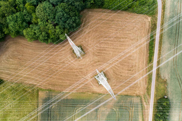 istock Agricultural area, fields, pylons and transmission lines 804384874