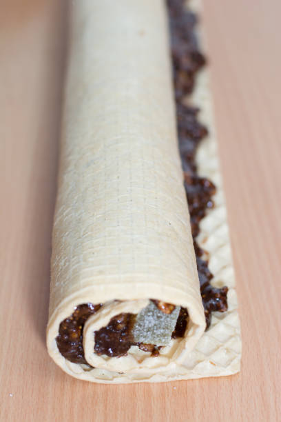 istock Rolling cake crust with chocolate and jelly candies. 804389542