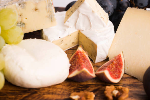 Assortment of cheese with fruits and grapes