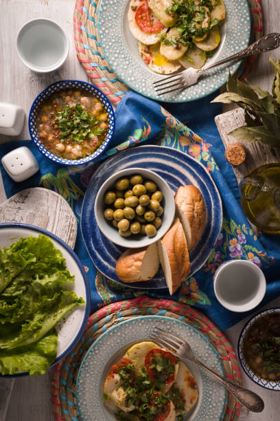 Greek dinner with traditional dishes on the  white table vertical