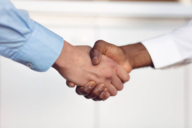 istock Handshake between african and a caucasian man 804410338
