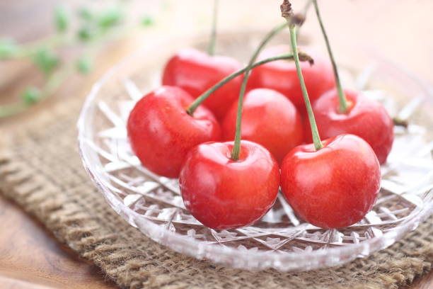 Cherry Japanese high-quality " Sato Nishiki" cherries on plate cherry colored stock pictures, royalty-free photos & images
