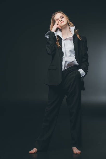 istock woman posing in male costume 804419182